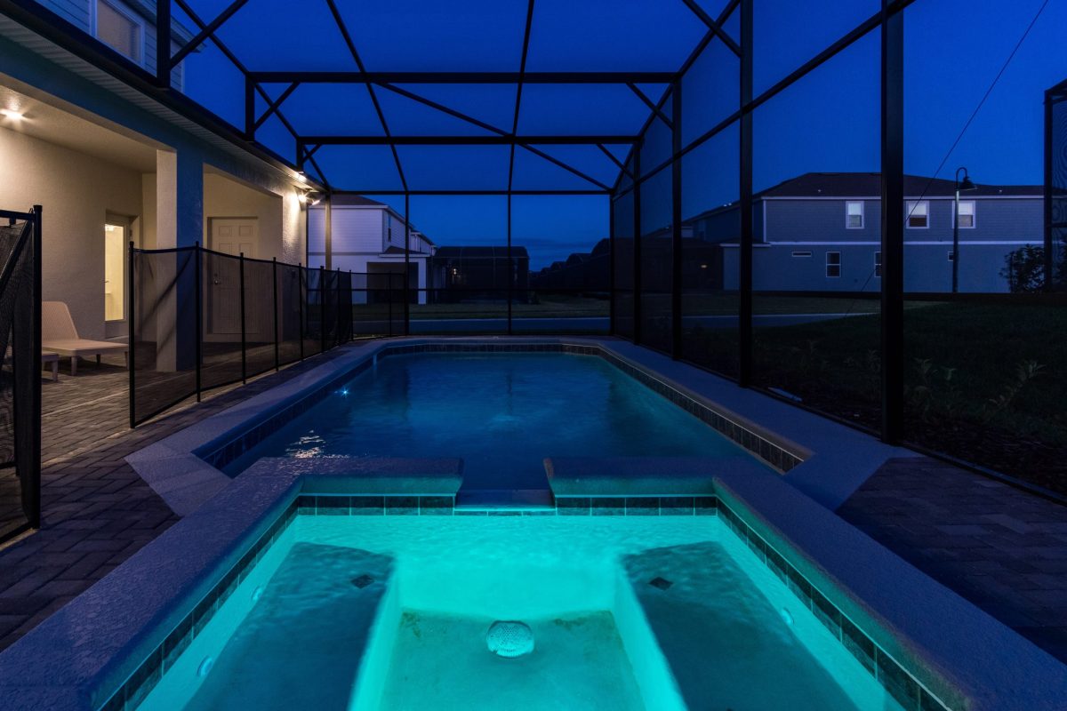 Pool area in vacation rental at night.