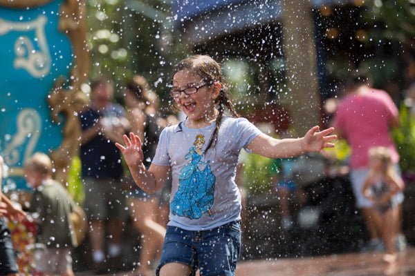 Little girl at magic kingdom enjoying the splash zone.