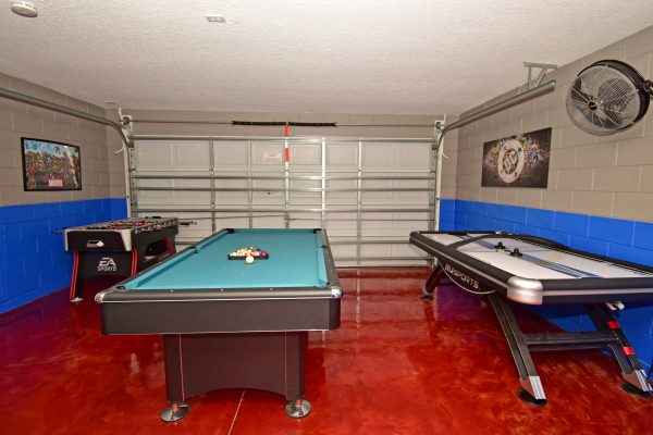 Games room showing air hockey, pool table, and foosball.
