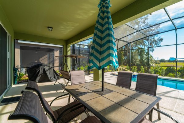 Outdoor dining and pool area in vacation rental, located in Solterra Resort.