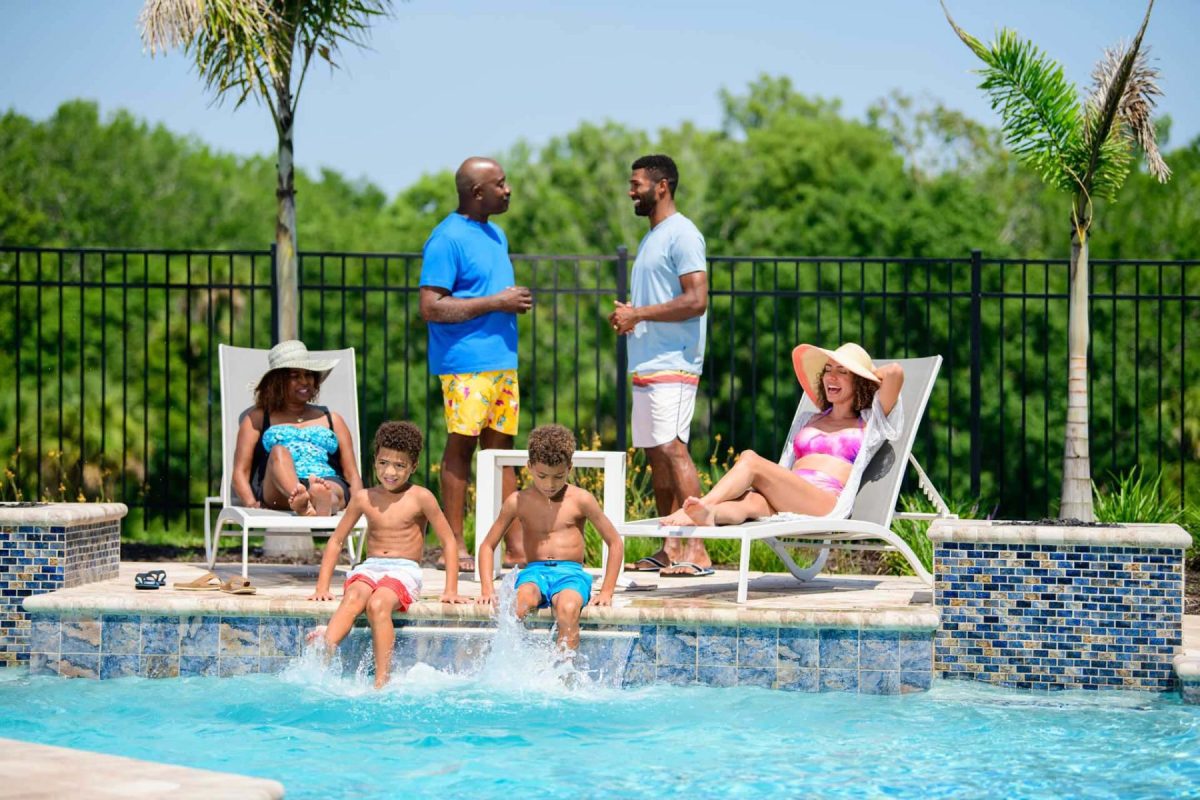 Family hanging out beside pool