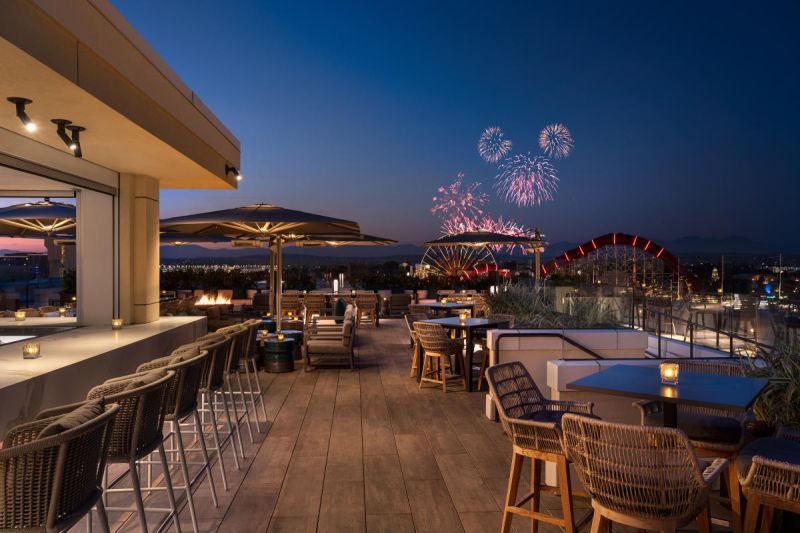 View of Disney firework show from a rooftop bar and restaurant