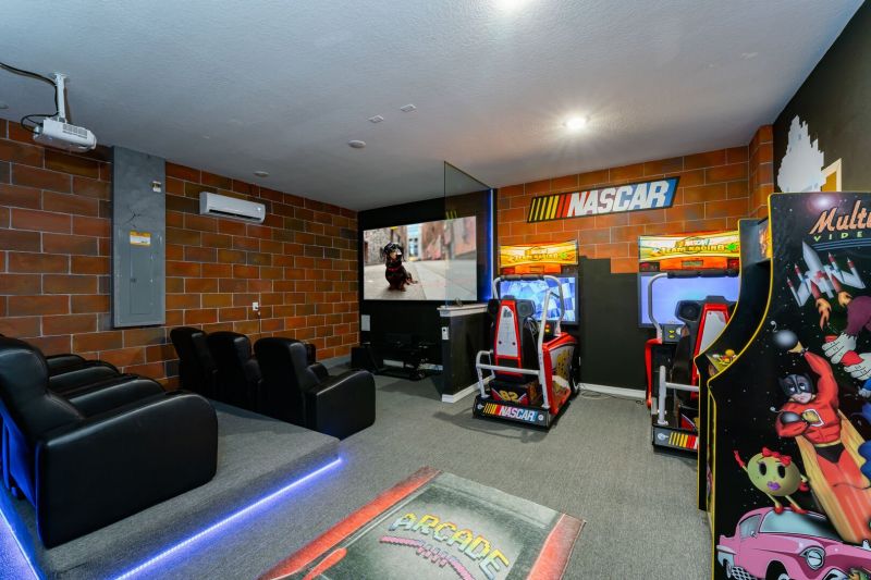 Games room inside a vacation rental managed by Orlando rent a villa with a NASCAR themed games room and fully screened in private pool