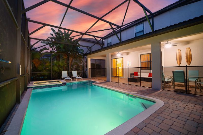 Pool area in a vacation rental near Disney managed by Orlando rent a villa with a screened in private pool and spa. 