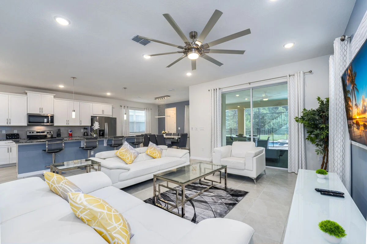 Open living room and kitchen with modern seating at S1949TPC - Tropical Delight vacation home. 