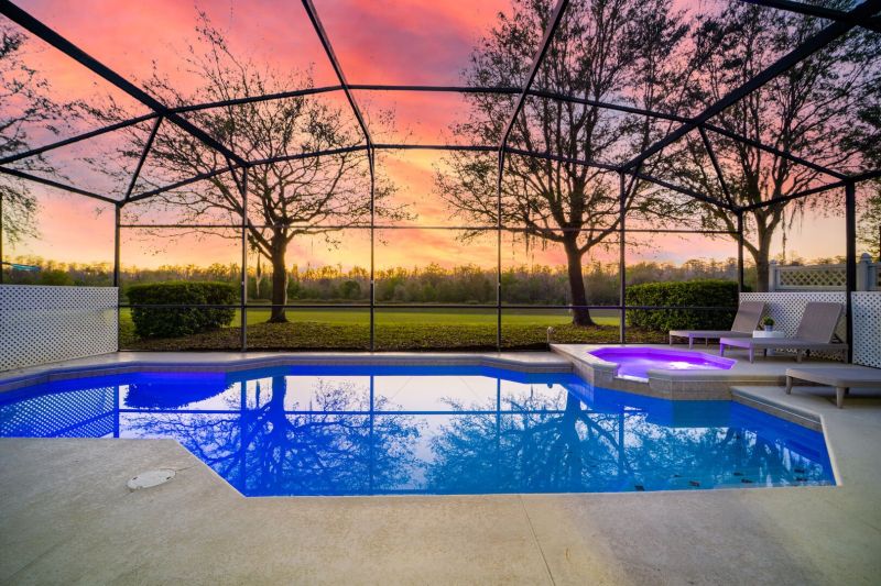 Private screened pool and spa with peaceful sunset views. Perfect for unwinding after a day in Orlando. 