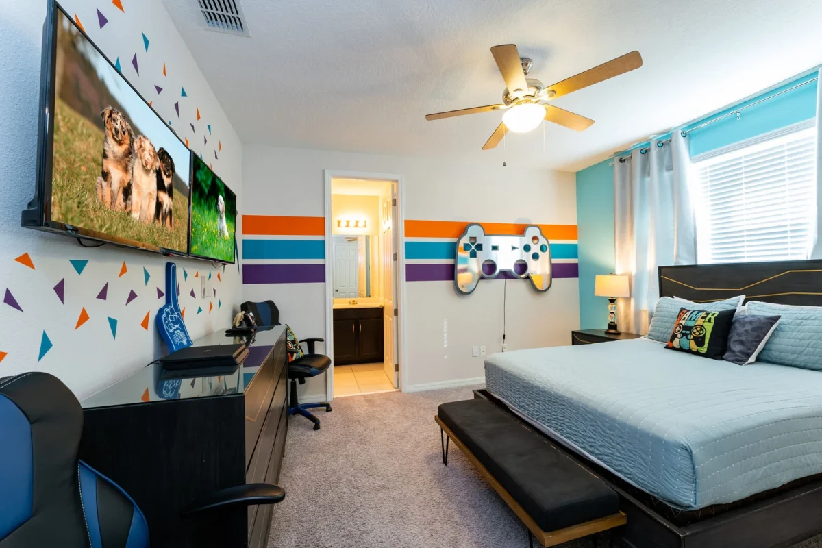 A fun, gamer themed bedroom designed for kids and teens, complete with a gaming set up and playful décor.