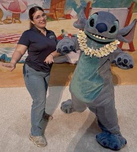 Orlando rent a villa team member posing for a picture with STITCH.