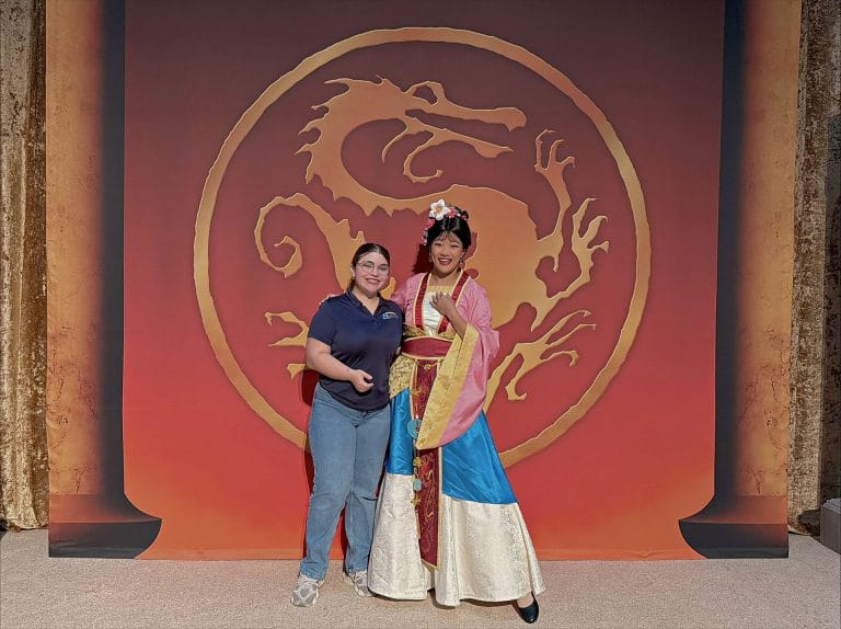 Orlando rent a villa team member posing for photo with Disney character.
