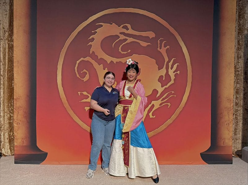 Orlando rent a villa team member posing for photo with Disney character.